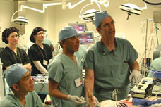 Dr. Ralph V. Clayman, right, prepares for a surgical procedure.